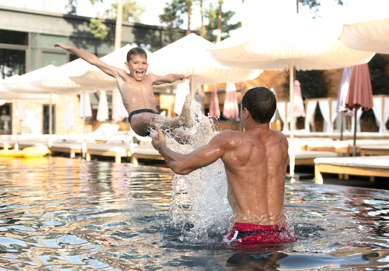 Father son enjoying day swimming pool together 1536x1072