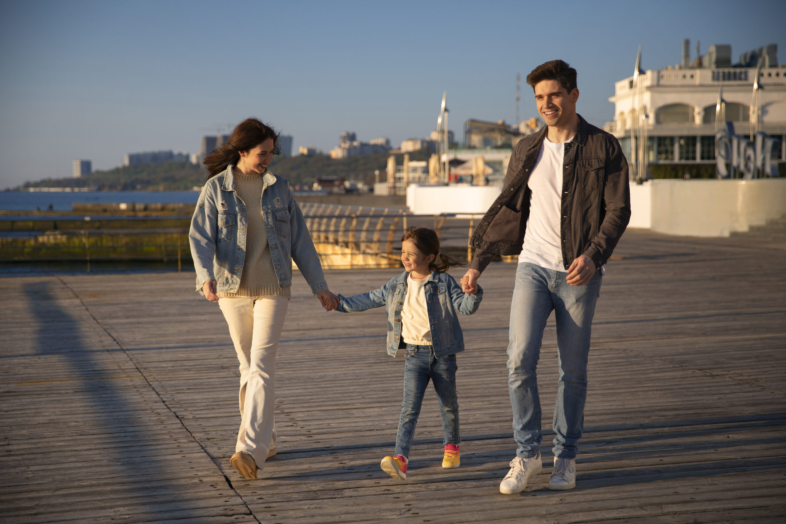 Full shot family hanging out jetty scaled
